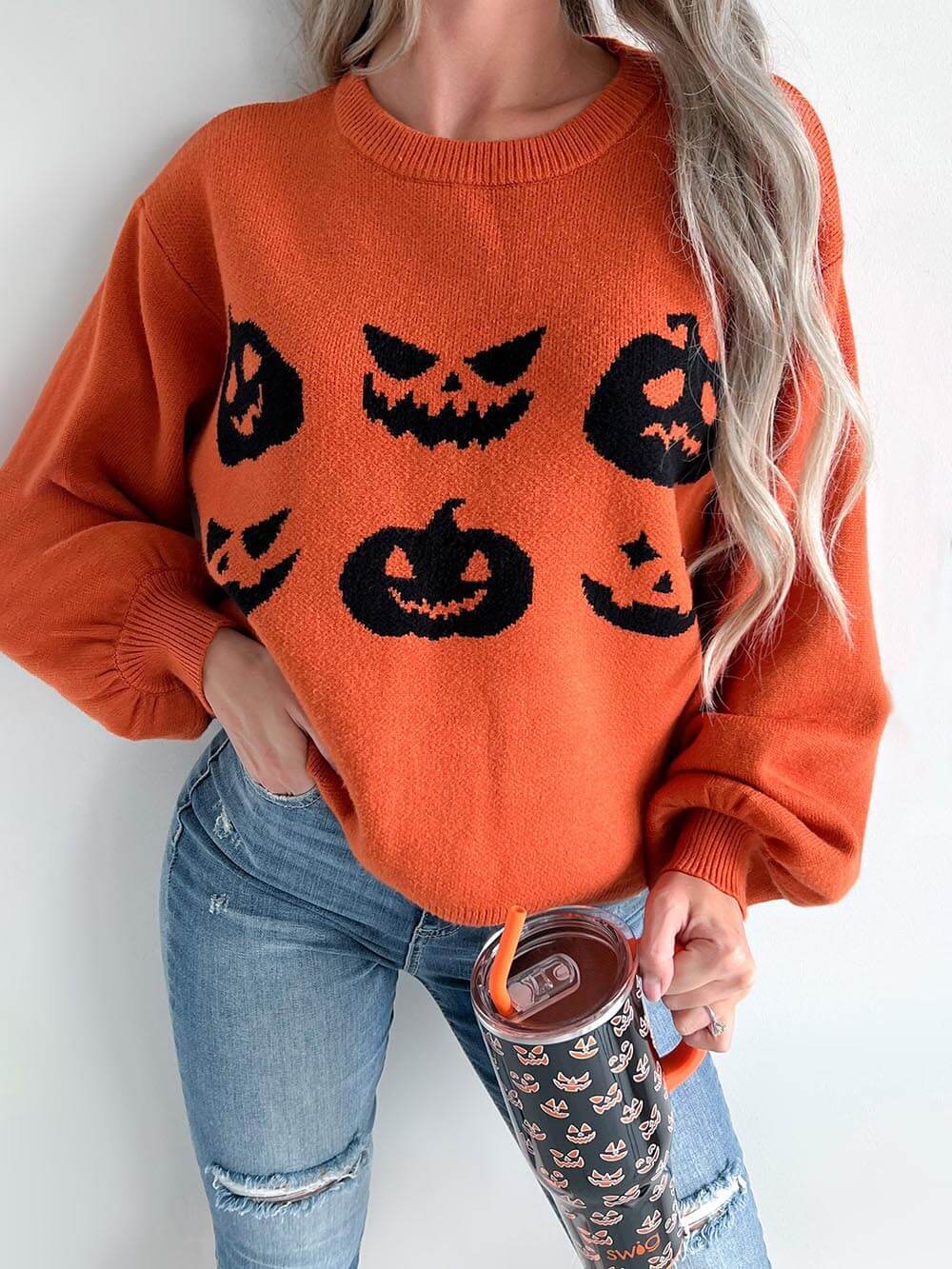 Women's orange pumpkin carving knit Halloween sweater — styled look