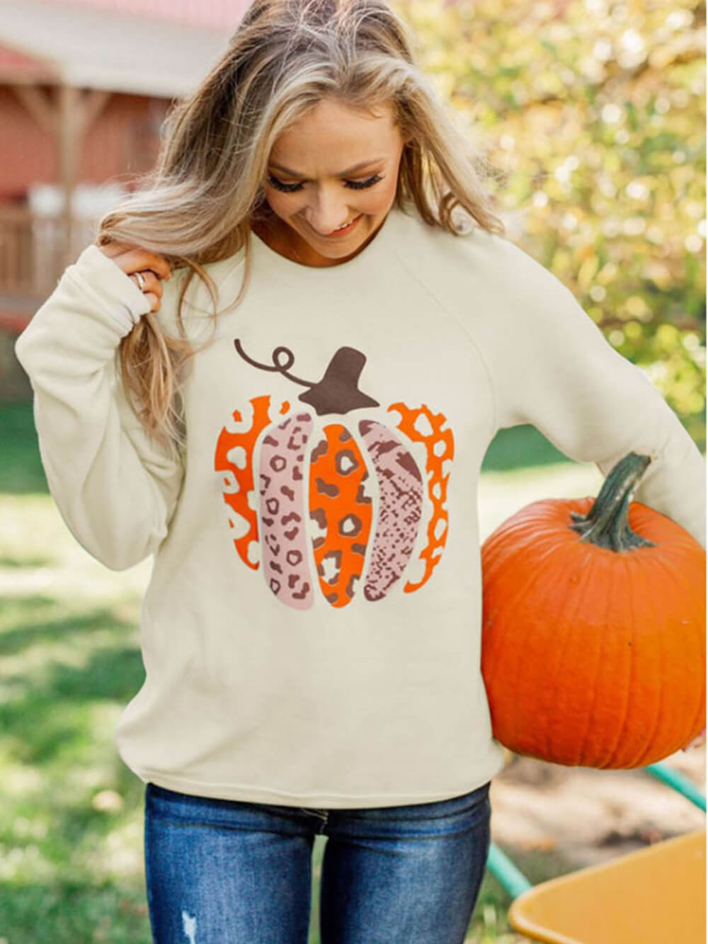 Women's pumpkin print graphic pullover with crew neckline and relaxed fit