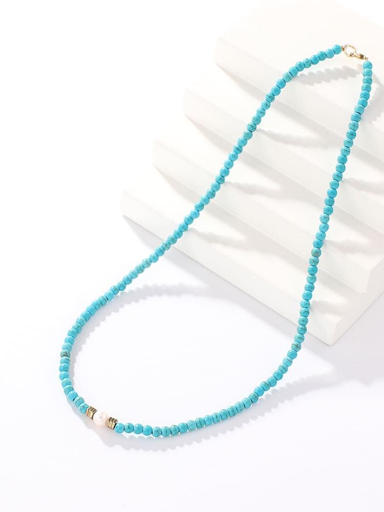 Women's turquoise and pearl beaded necklace — close-up detail