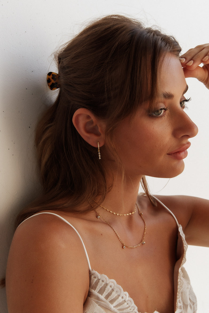 Women's gold zirconia stud earrings — alternate angle