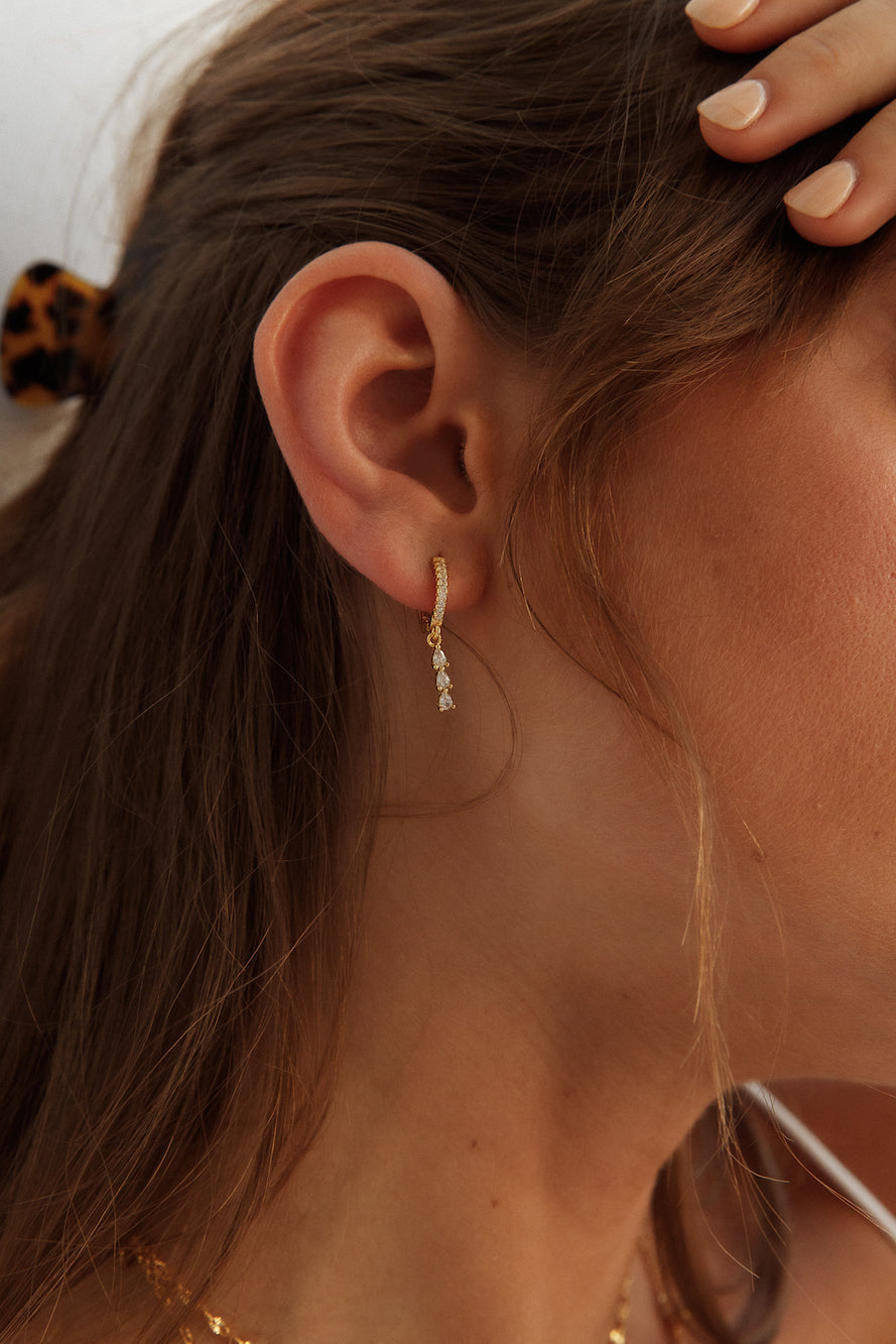 Women's gold zirconia stud earrings — alternate angle