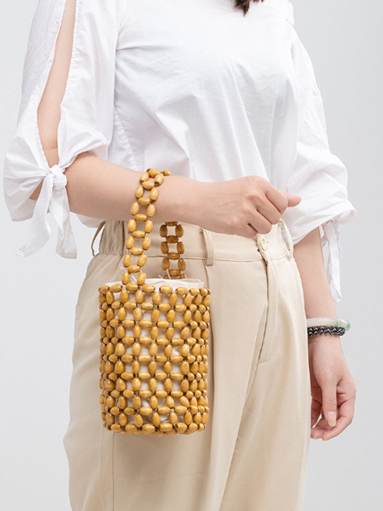 Women's woven wooden bead bucket bag